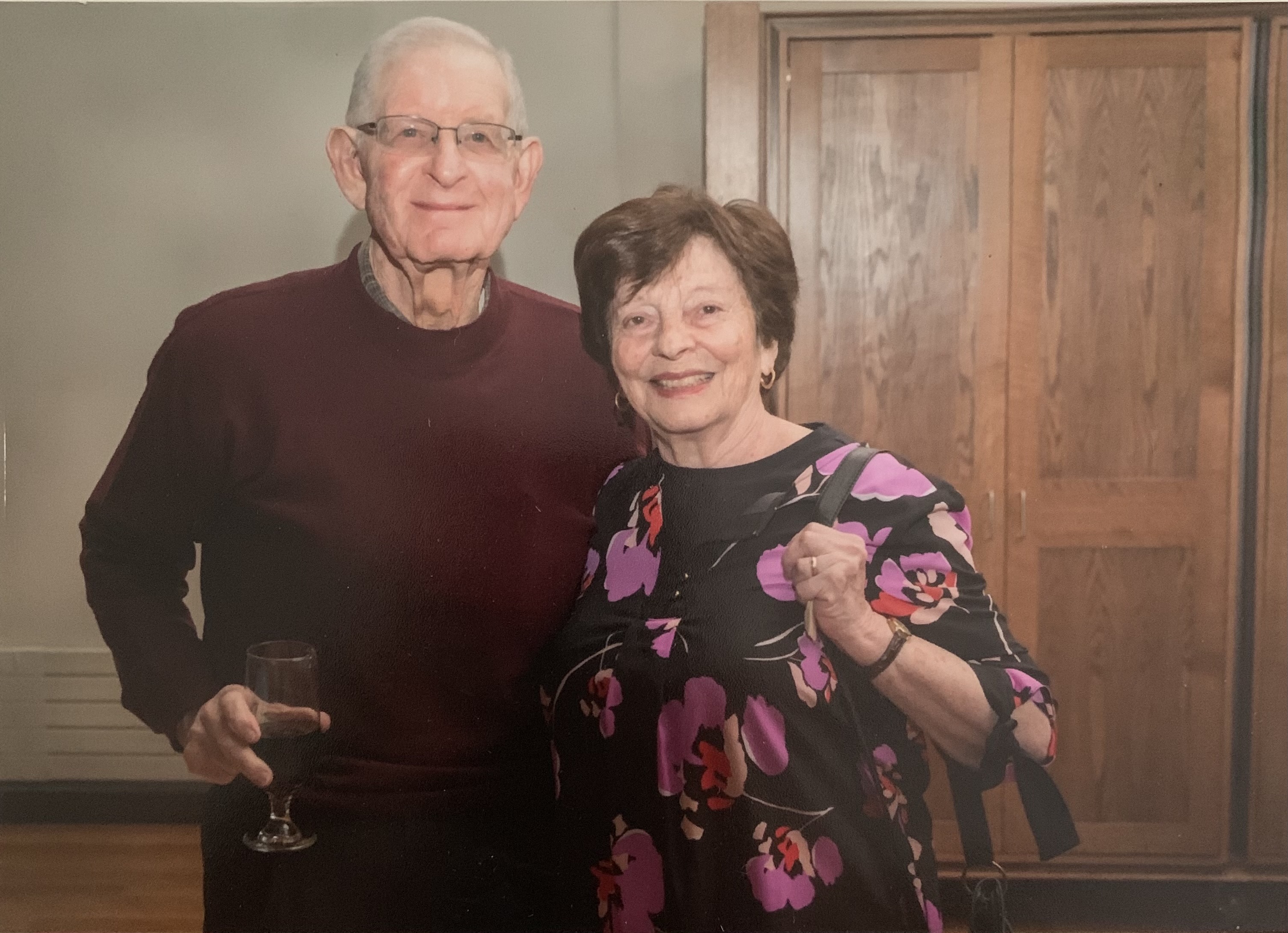 a man and a woman, standing next to each other, smiling